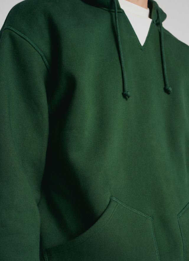 green sweatshirt with white collar